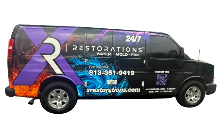 X Restorations service van with purple branding for water, mold, and fire restoration.
